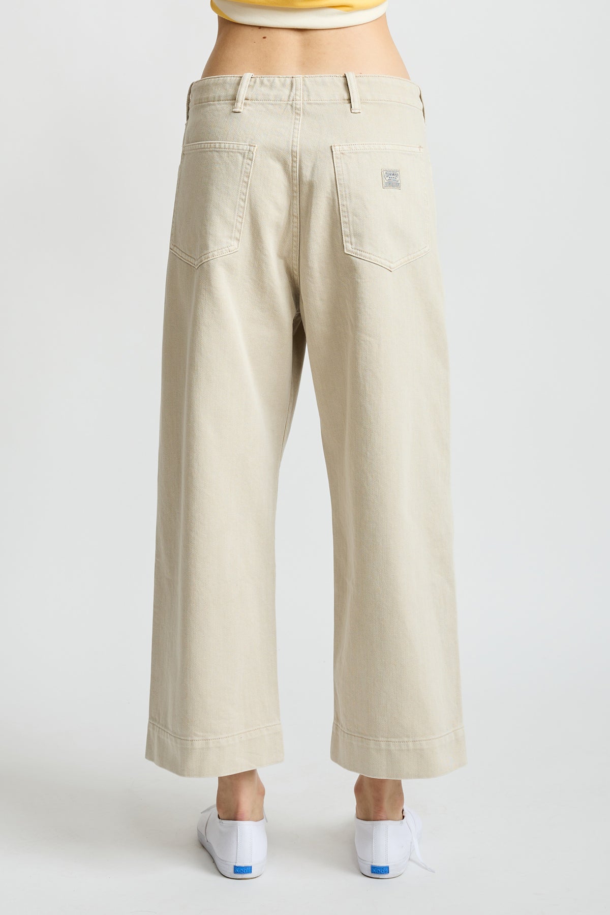 Light brown work pants with back pockets and reinforced seams, shown from rear view.